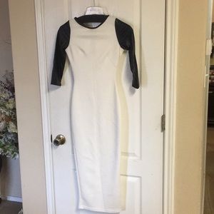 Fitted white dress with black leather-like sleeves